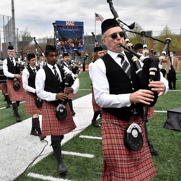 Macalester Pipe Band walking on field