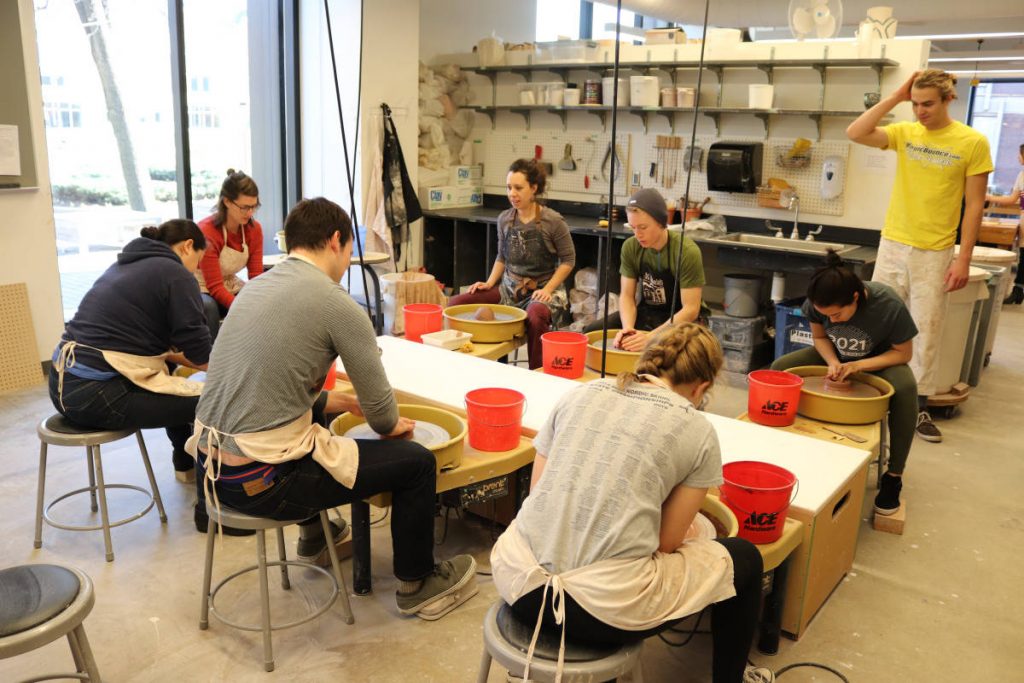 Students throwing pots at the wheels in the Margaret H. Soltis Ceramics Studio. (Photo by Nicolas Koch-Gallup)