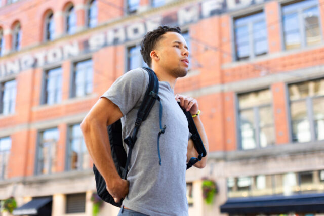 Mack Williams walks down the street holding a backpack in St. Paul