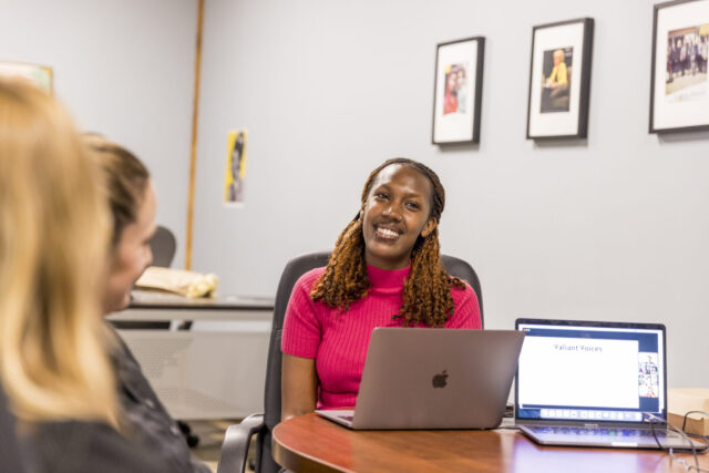 Kampe Rushoka ’26 works on a laptop during a meeting with colleagues at Global Rights for Women