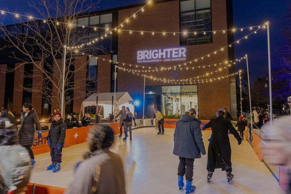 Community members skate on a temporary ice rink installed in front of the Janet Wallace Fine Arts Center at the Brighter campaign launch party. Twinkle lights shine overhead.