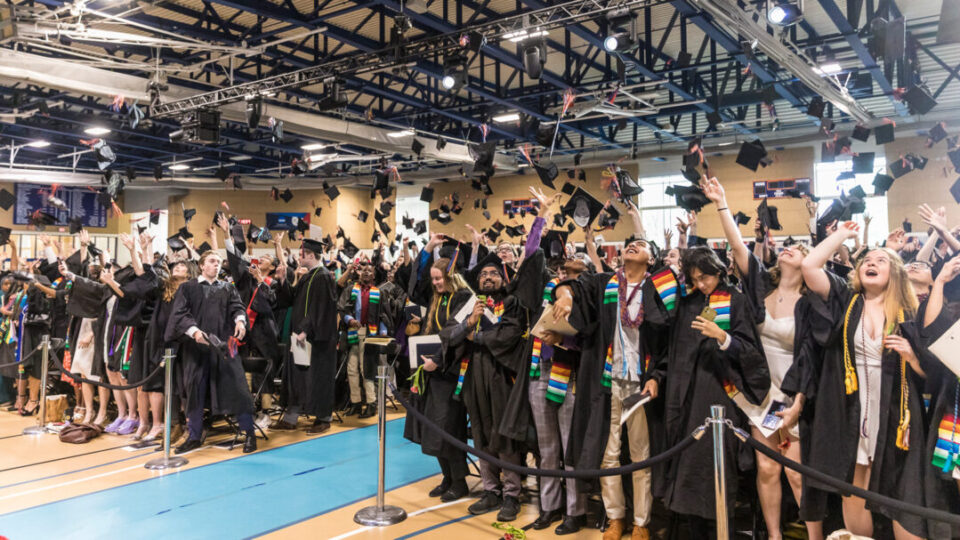 Graduates celebrate with the traditional cap toss at the end of the 2023 commencement ceremony at Macalester College.