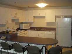 A kitchen in a Grand-Cambrige Apartment unit