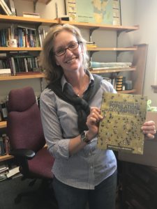 Picture of Professor Holly Barcus holding a book