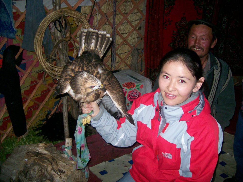 Photo of Amangul Shugatai holding a hawk