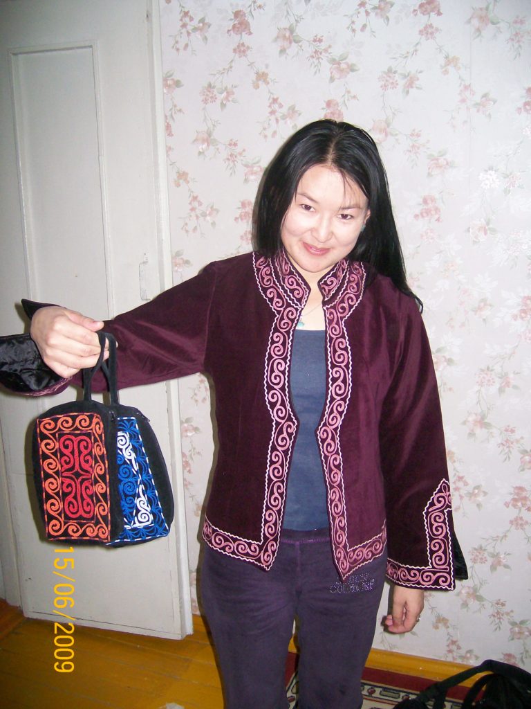 A photo of Nurshash Shugatay holding a purse