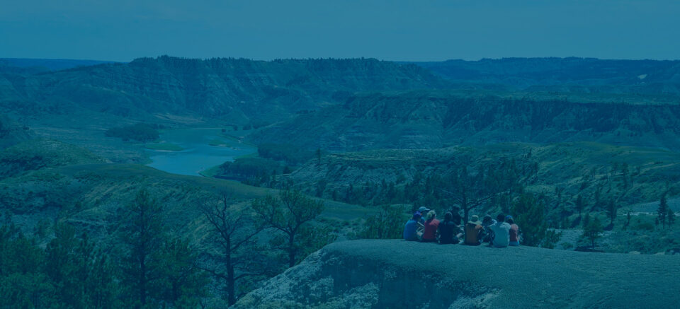 Students sit above a gorge