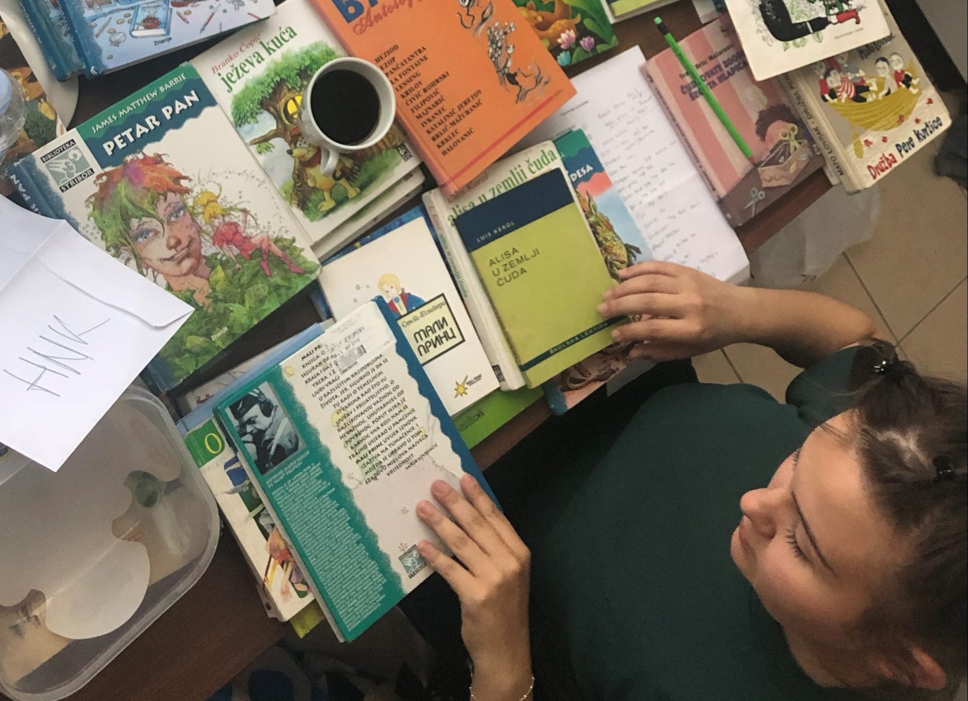 Photo showing Janica sorting childrens' books