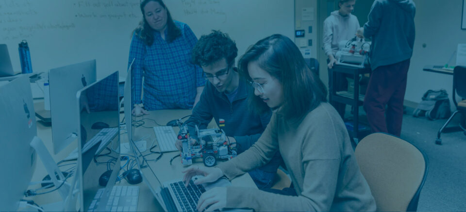 Photo of two students at a computer