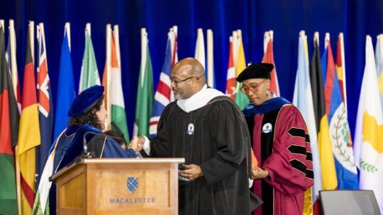 Macalester College President Suzanne M. Rivera presents The Honorable Andrew Gordon ‘05 with the honorary degree of Doctor of Humane Letters. 