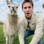 A student poses with a llama in Argentina