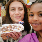 Two students pose with food in the Netherlands