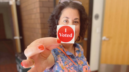 President Rivera holds an I Voted sticker