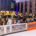 Mac band members play on the edge of the ice rink at the Brighter campaign launch event.