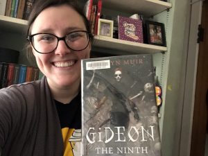 Author holding copy of Gideon the Ninth by Tasmyn Muir