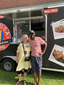 Jan with food truck staff at the Fall Luncheon