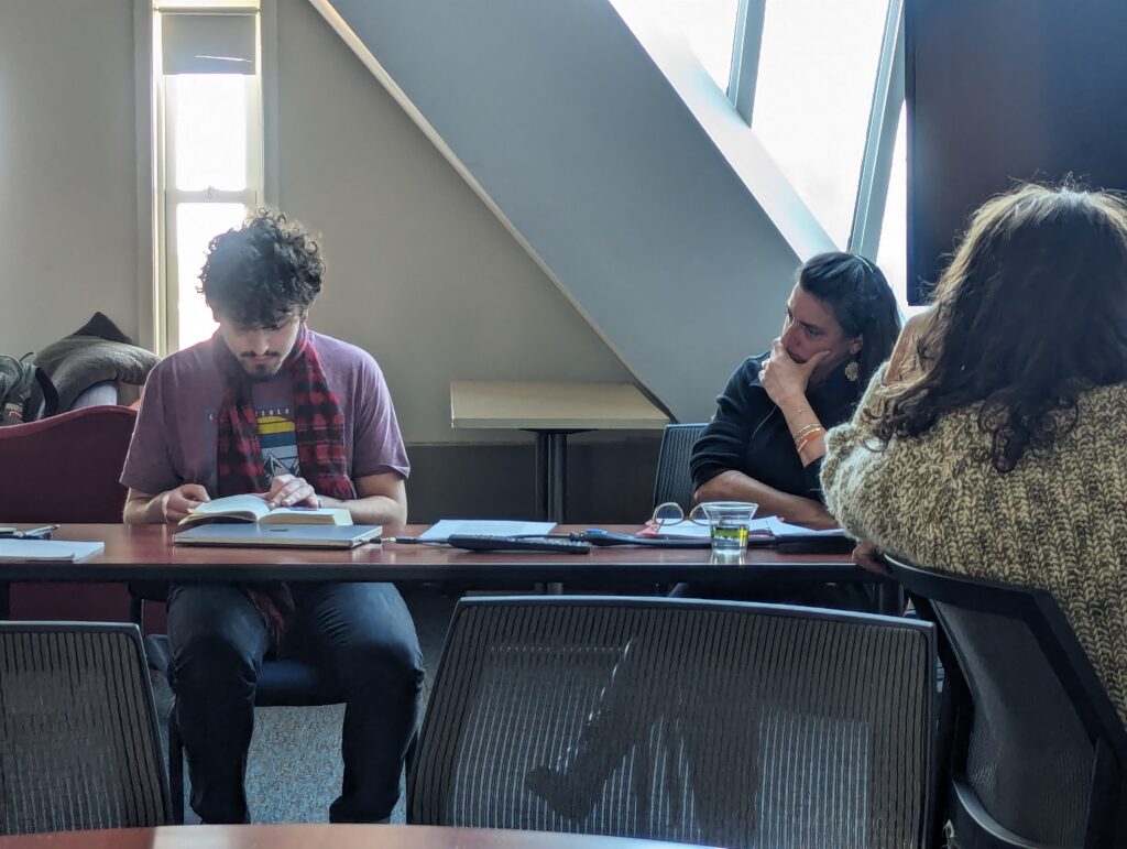 Student reading during Dr. Akbari's literary salon