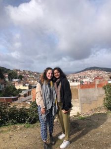 Mina and a friend standing in front of the Granada skyline.